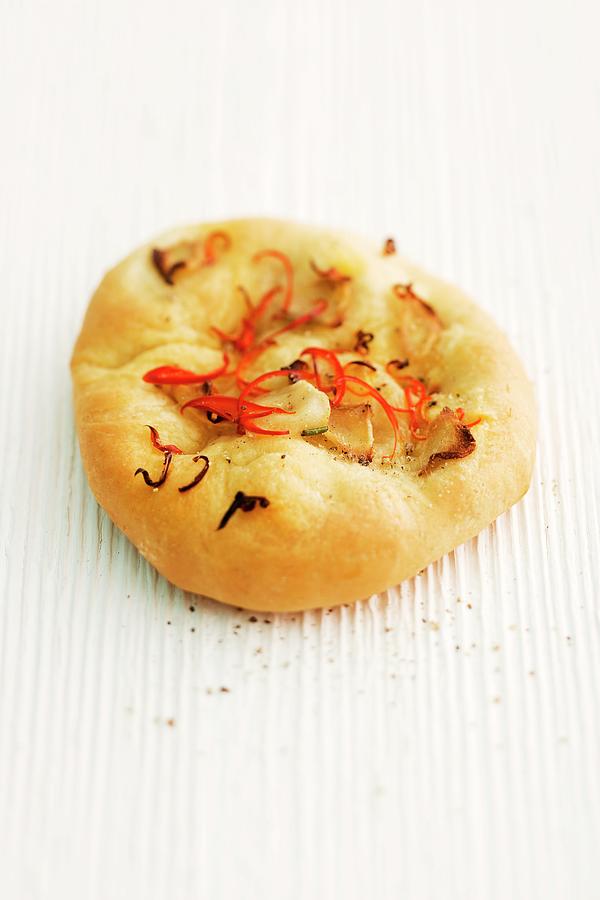 Focaccia With Ginger And Chilli On A Wooden Surface Photograph by Michael Wissing