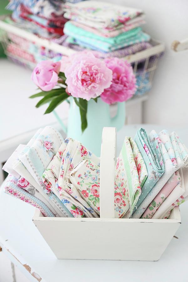 Folded, Rose-patterned Fabrics In Pastel Shades Arranged In White Wooden Trug - Vintage Ambiance Photograph by Syl Loves