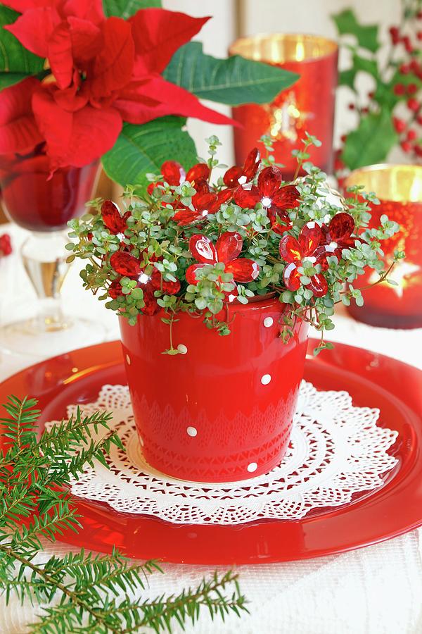 Foliage Plant With Flower-shaped Fairy Lights In Red Pot On Plate; Poinsettia In Background Photograph by Angelica Linnhoff