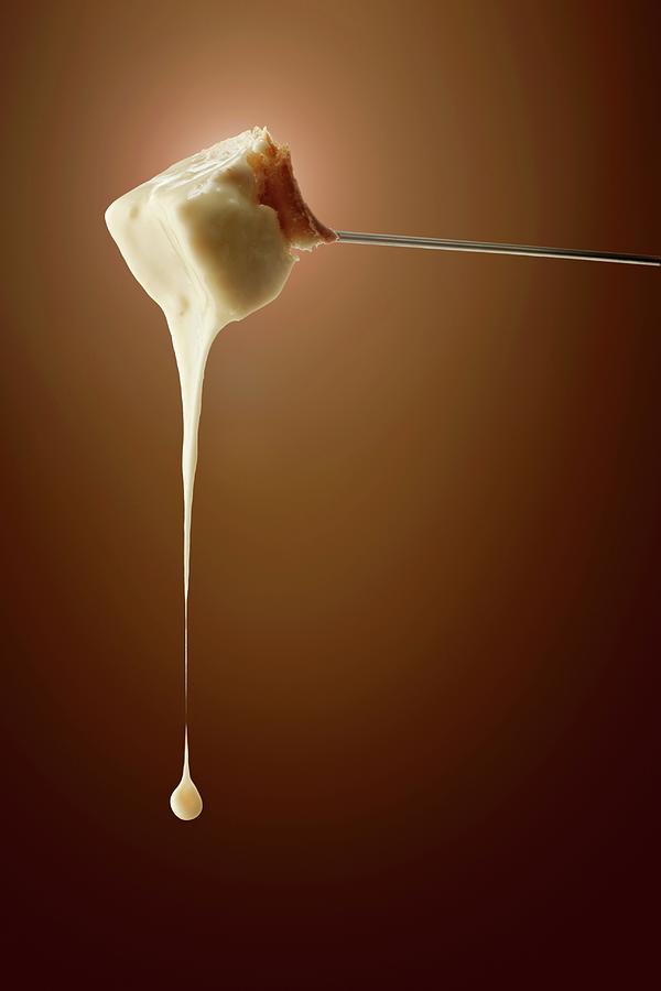 Fondue Cheese Dripping From A Fork Photograph by Krger & Gross