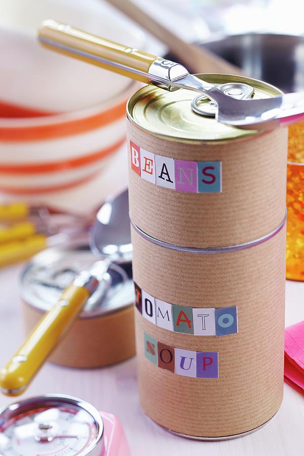 Food Cans Wrapped In Brown Paper And Labelled With Alphabet Stickers Photograph by Franziska Taube