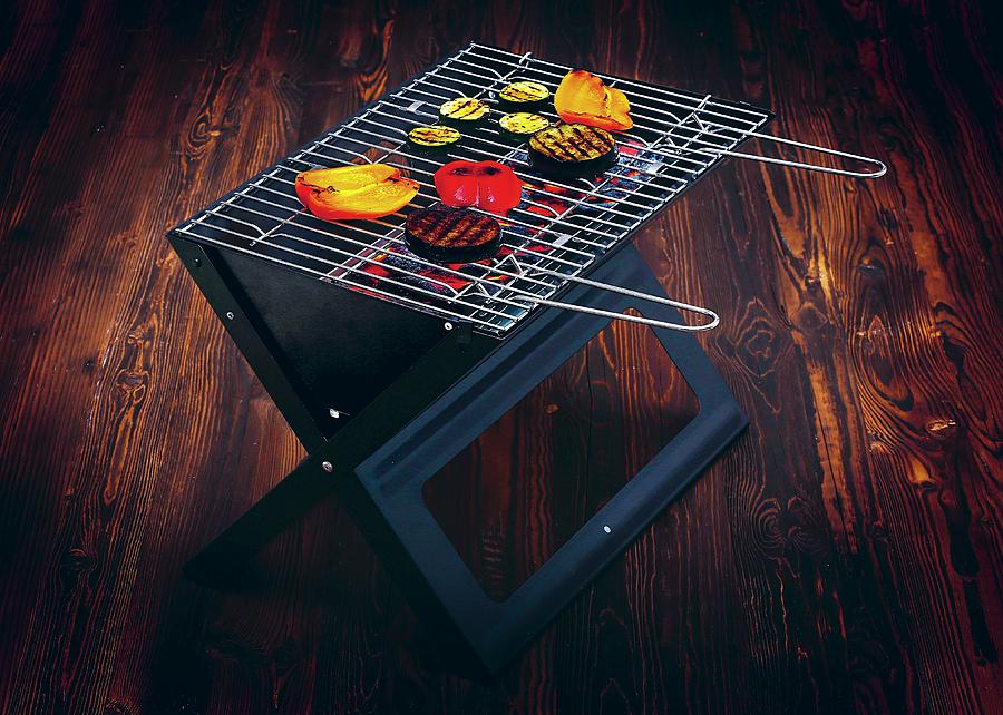 Food On A Folding Grill On A Dark Wooden Surface Photograph by Jalag / Michael Bernhardi