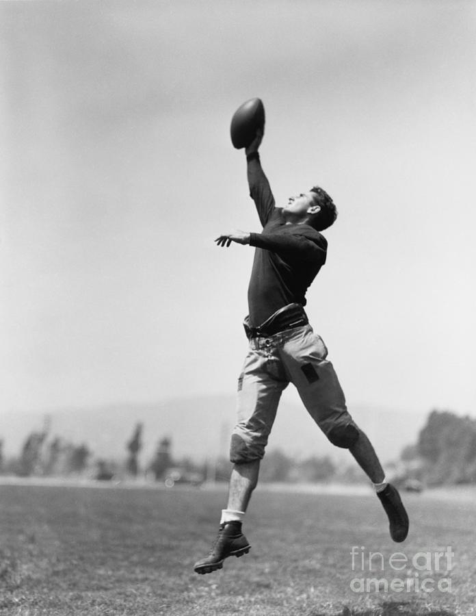 Play Photograph - Football Player Catching Ball by Everett Collection Play Photograph - Football Player Catching Ball by Everett Collection