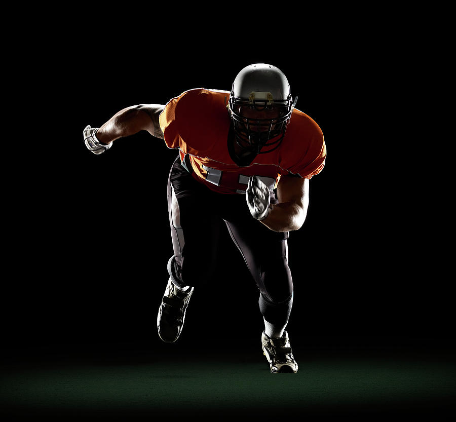 Football Player Exploding From 3-point Photograph by Lewis Mulatero