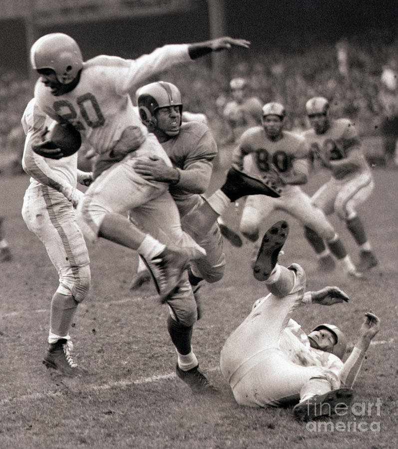 Football Player Leaping Through Air Photograph by Bettmann Football Player Leaping Through Air Photograph by Bettmann