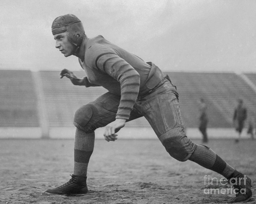 Football Player Posing In Tackle by Bettmann