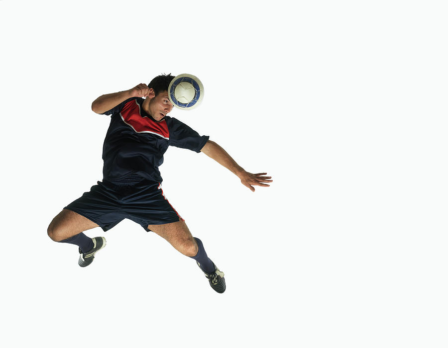 Footballer Heading Ball In Mid-air Photograph by John Lamb