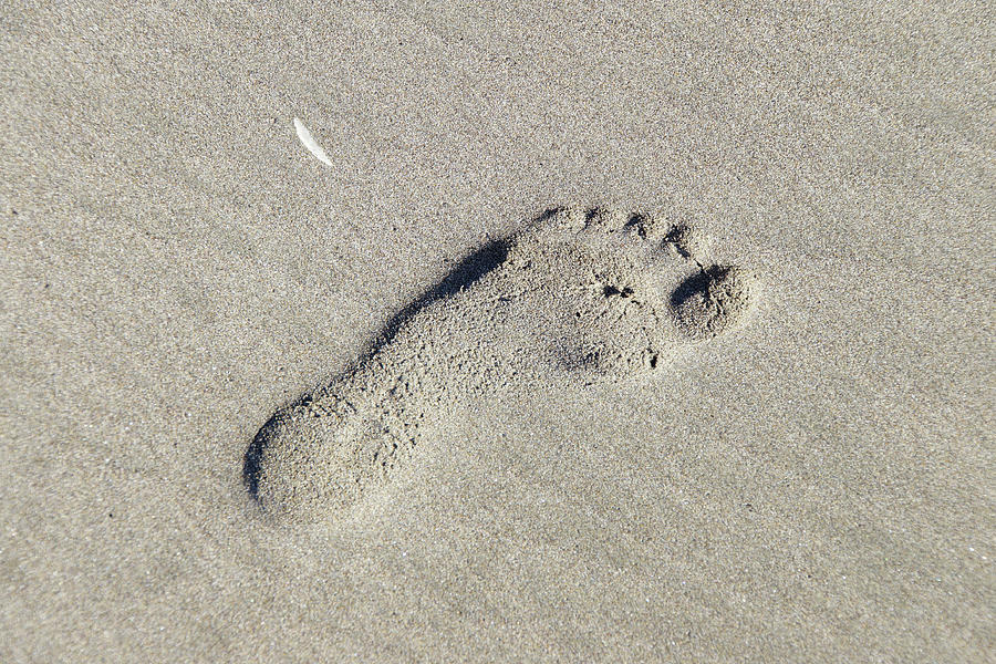 Footprint in drifting sand Photograph by Steve Estvanik