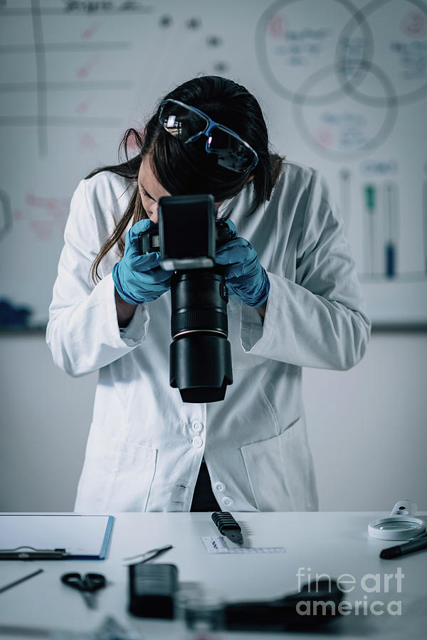 forensics-expert-examining-crime-scene-evidence-photograph-by-microgen