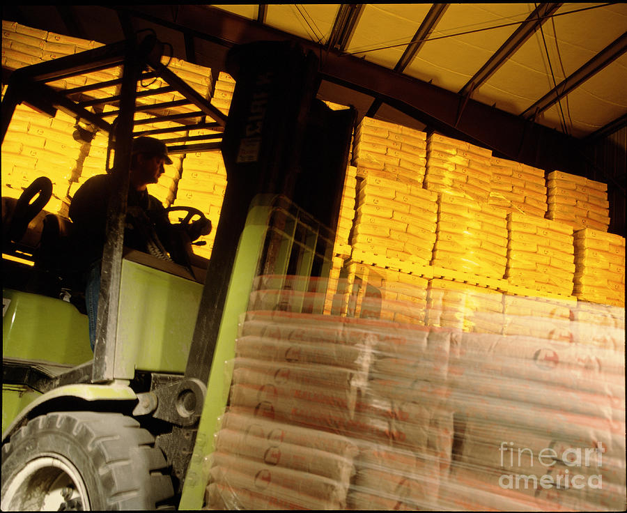 Fork-lift Truck Carries Cement Bags In A Warehouse Photograph by Deep Light Productions/science Photo Library