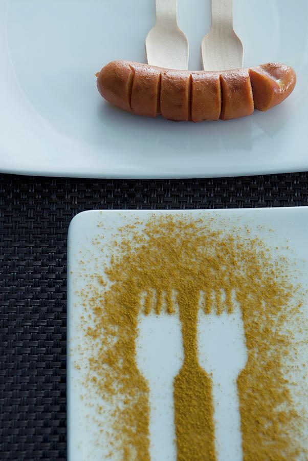Fork Prints In Curry Powder On A Plate And A Sausage Photograph by Matteo Manduzio