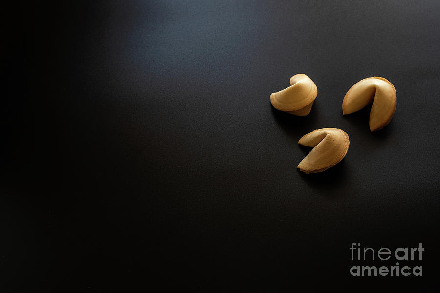 Fortune cookies on black background. Photograph by Joaquin Corbalan