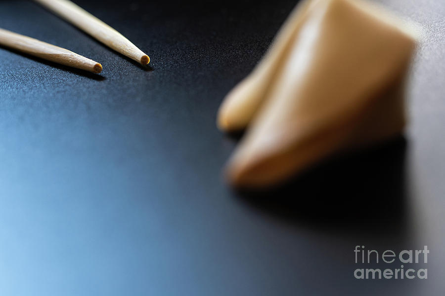 Fortune cookies on black background with chopsticks and copy space. Photograph by Joaquin Corbalan