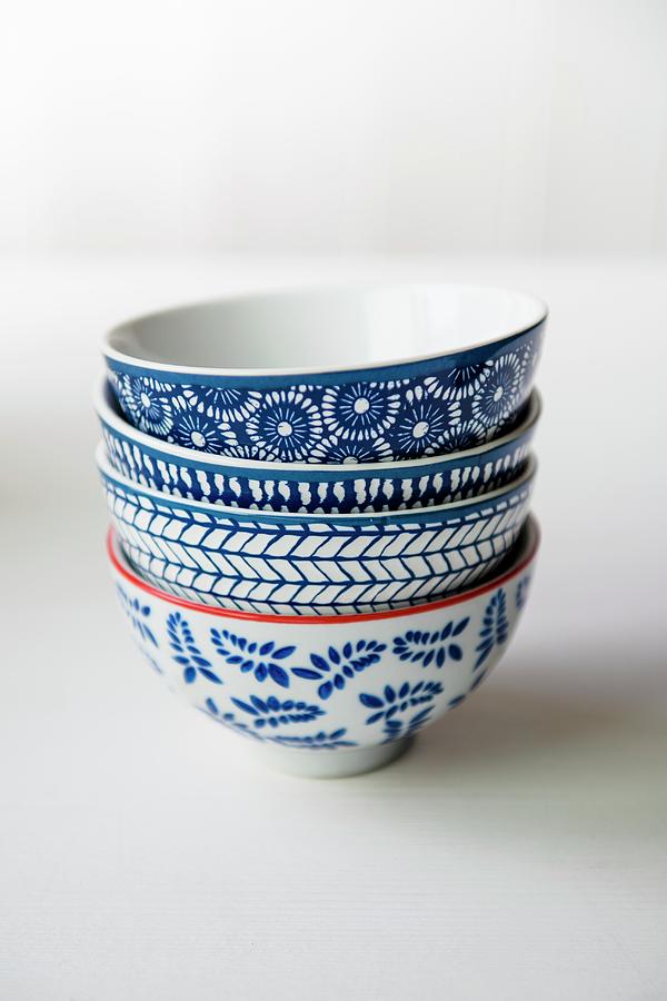 Four Blue And White Patterned Bowls On A White Surface Photograph by Magdalena Hendey