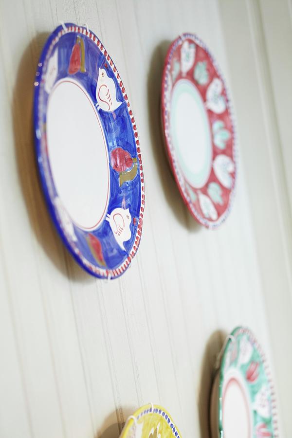 Four Decorative Plates With Red, Blue, Green And Yellow Rims Photograph by Charlotte Tolhurst