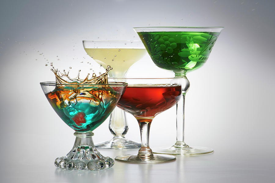 Four Different Cocktails In Glasses Against A Gray Background Photograph by Jim Scherer