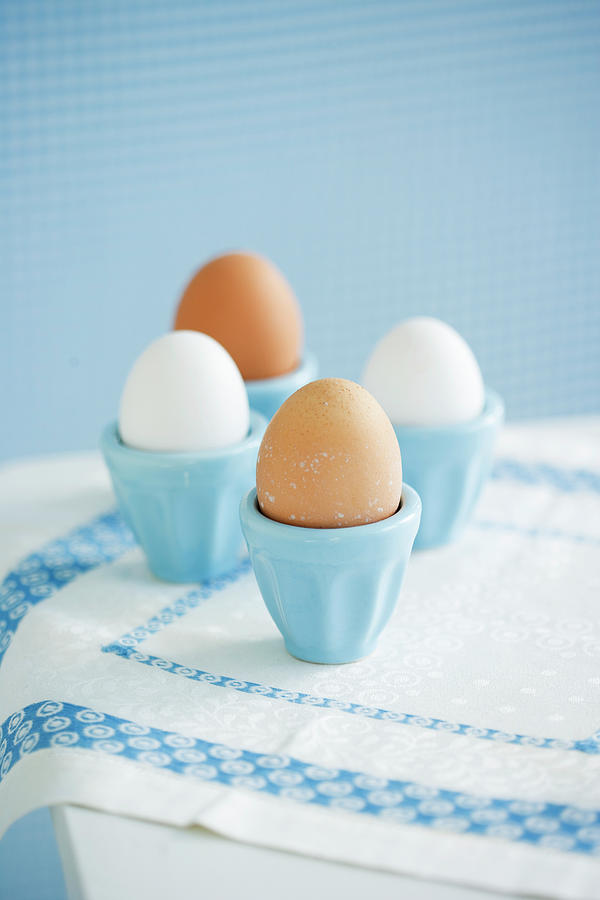 Four Eggs In Eggcups Photograph by Colin Cooke