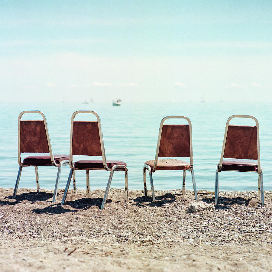 Four Empty Chairs By The Water Photograph by Christian Senger