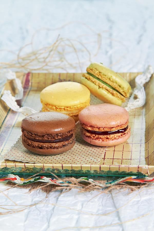 Four Macaroons On A Tray Photograph by Miriam Rapado