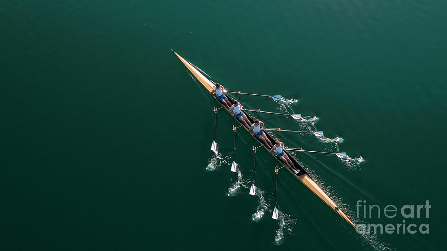Four Male Athletes Sculling On Lake Photograph by Simonkr