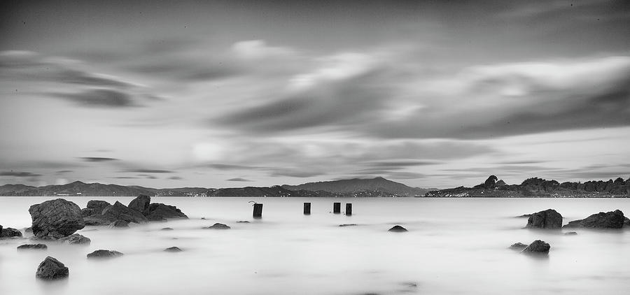 Black And White Photograph - Four Pilings And Mount Tam by Geoffrey Ansel Agrons