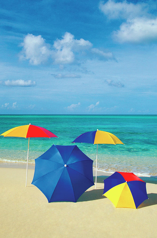 Four Umbrellas On The Smooth Sands Of Photograph by Medioimages ...