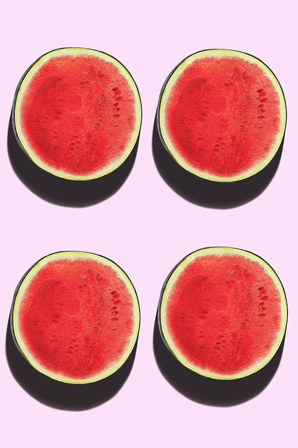Four Watermelon Halves On A Pink Background Photograph by Roberto Rabe