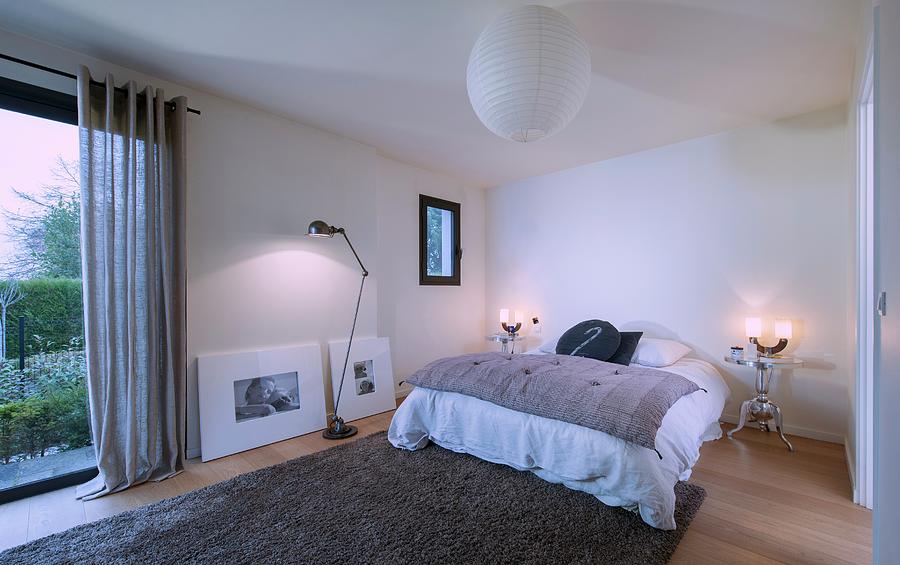 Frameless Bed And Two Silver Metal Bedside Tables In Minimalist Bedroom Photograph by Christophe Madamour