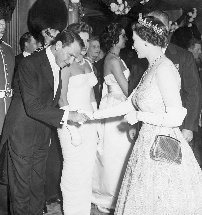 Frank Sinatra Bows To Queen Elizabeth II Photograph by Bettmann