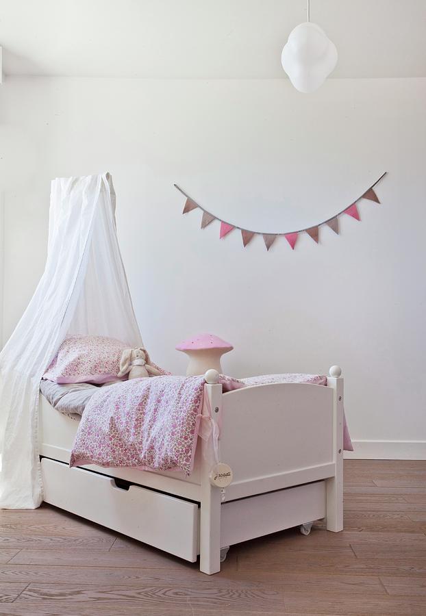Free-standing Bed Below Canopy In Front Of Bunting On Wall Photograph by Anne-catherine Scoffoni