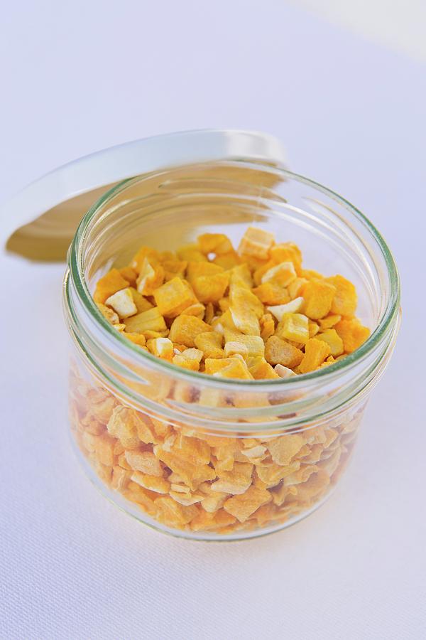 Freeze Dried Mango Pieces In A Jar Photograph by Esther Hildebrandt