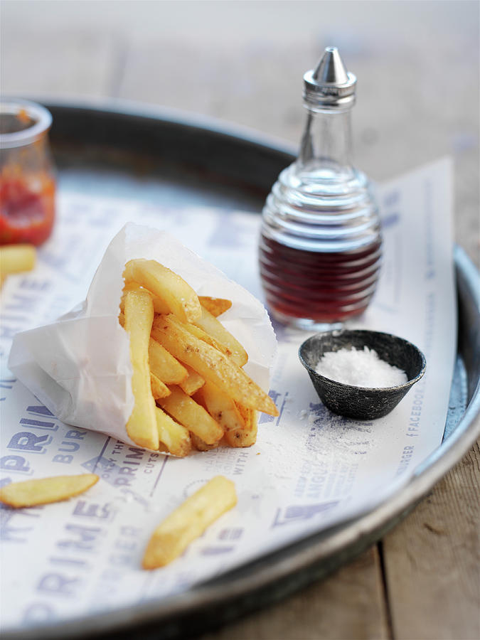French Fries In A Paper Bag, With A Small Bowl Of Salt Photograph by Ian Garlick