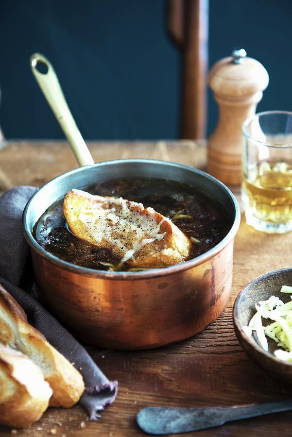 French Onion Soup With A Slice Of Baguette In A Copper Pan Photograph by Veronika Studer