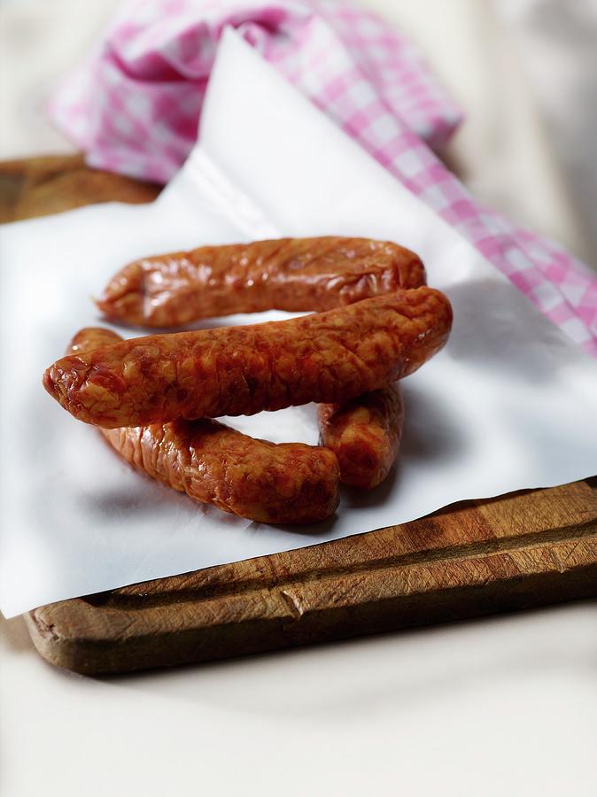 French Smoked Sausages On Wax Paper Photograph by Frdric Perrin