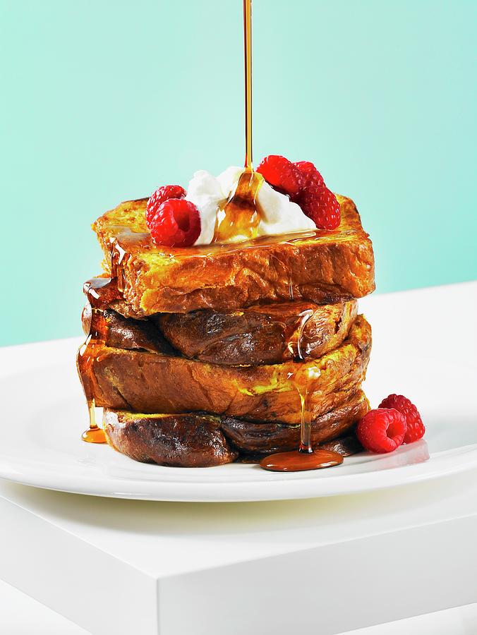 French Toast With Maple Syrup, Whipped Cream And Raspberries Photograph ...