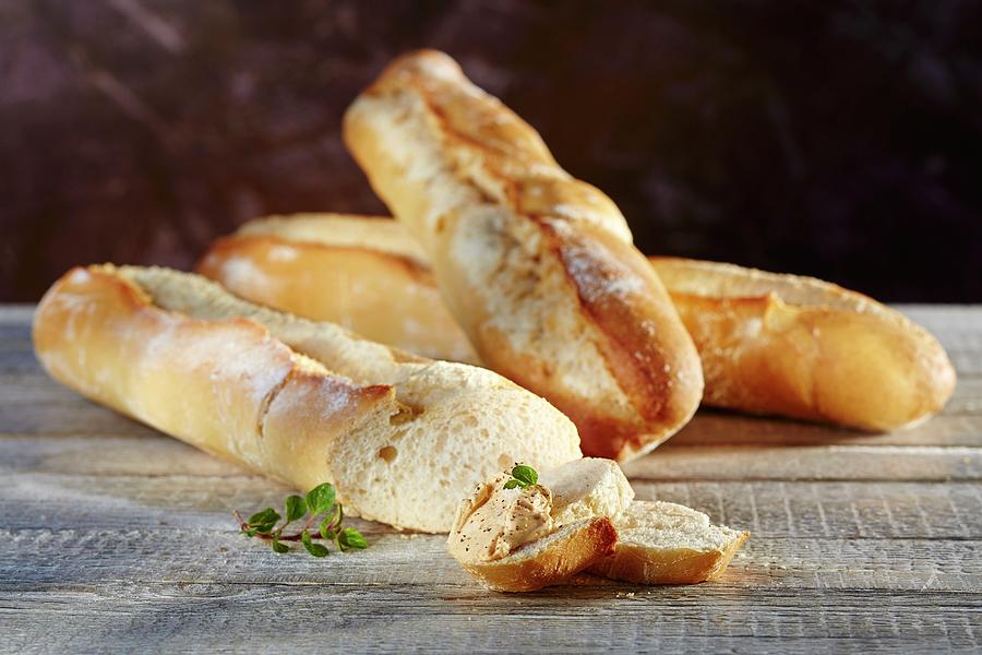 French Wheat Baguettes With A Dip And Oregano Photograph by Niklas Thiemann