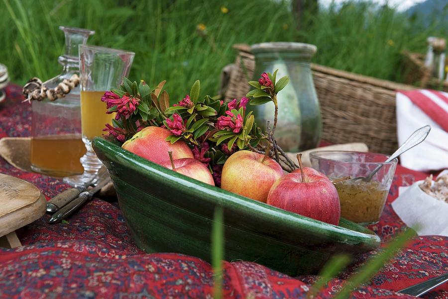 Fresh Apples And Sprigs Of Blossoms In A Green Ceramic Bowl On A Picnic Rug Photograph by Matteo Manduzio