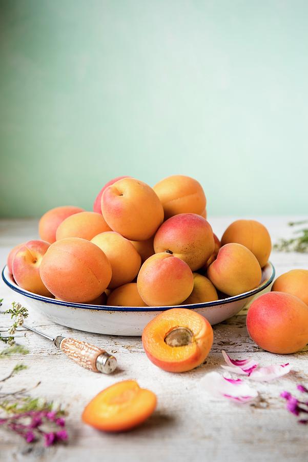 Fresh Apricots In An Enamel Bowl Next To A Knife Photograph by Magdalena Hendey
