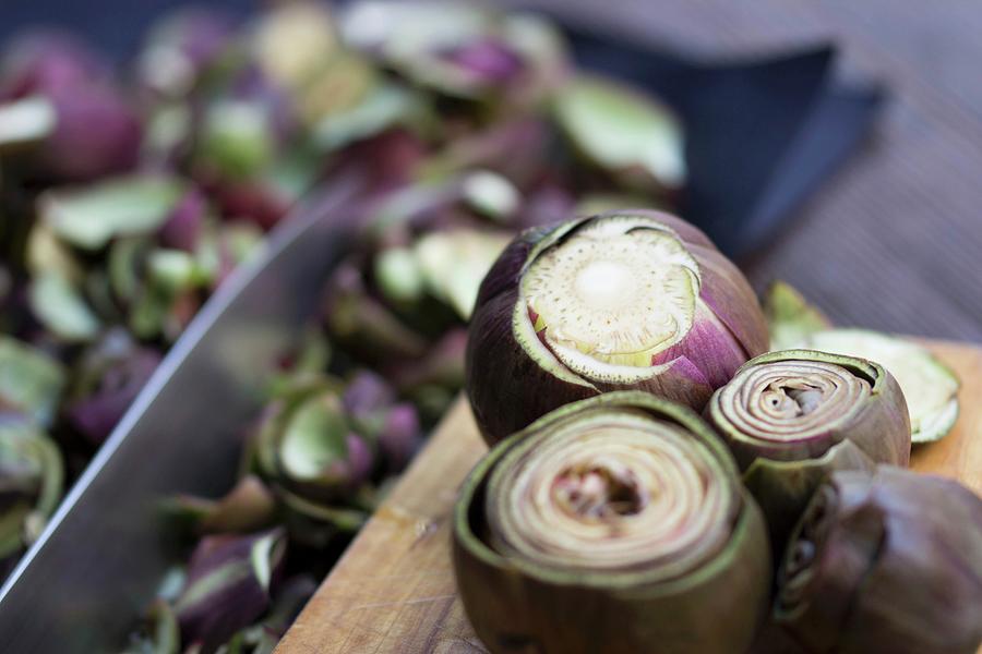Fresh Artichokes For Preserving On A Wooden Board With A Knife Photograph by Charlotte Von Elm