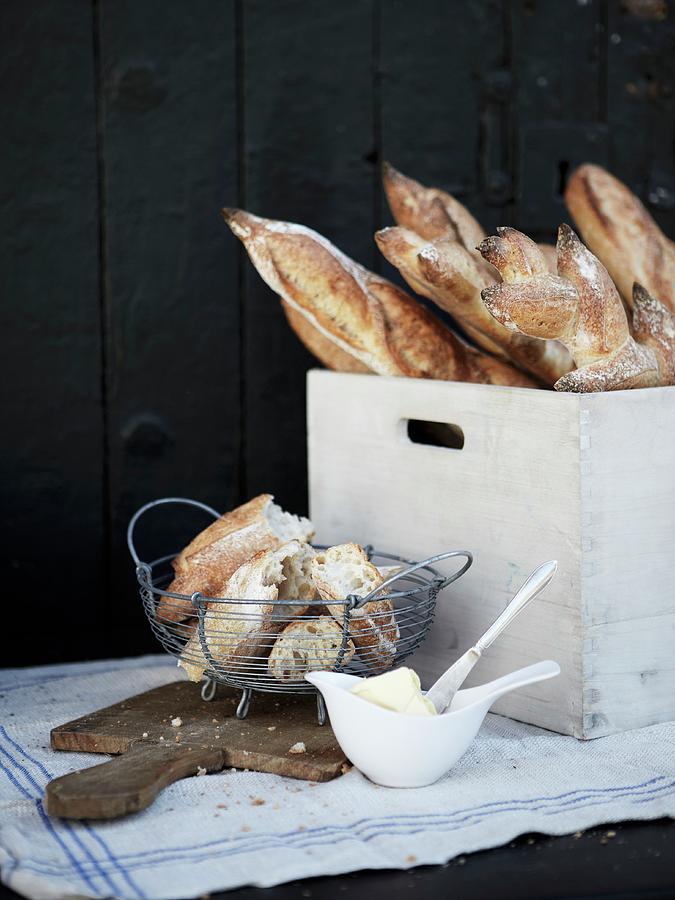 Fresh Baguettes And A Wooden Crates And In A Wire Basket Photograph by Magnus Carlsson