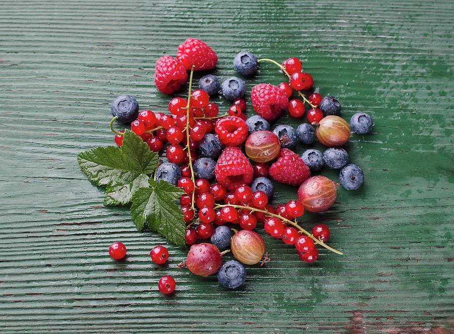 Fresh Berries On A Wooden Table Photograph by Ewgenija Schall