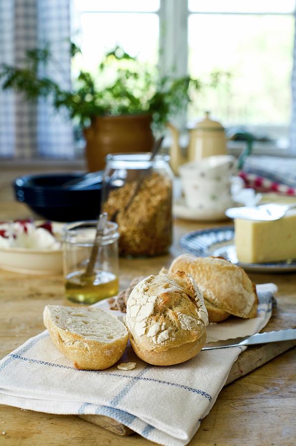 Fresh Breakfast Rolls On Rustic Dining Table Photograph by Mans Jensen