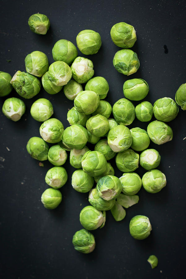 Fresh Brussels Sprouts On A Black Background Photograph by Manuela Rther