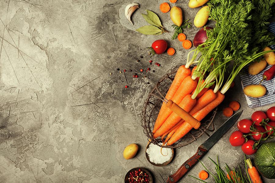 Fresh Carrots Bunch And Vegetables On Rustic Grey Stone Background Photograph by Natalia Klenova