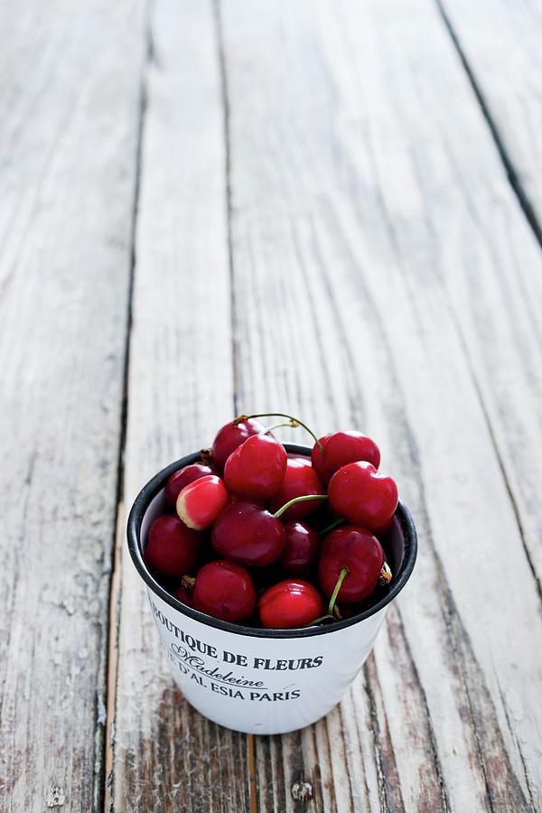 Fresh Cherries In An Enamel Cup Photograph by Maricruz Avalos Flores