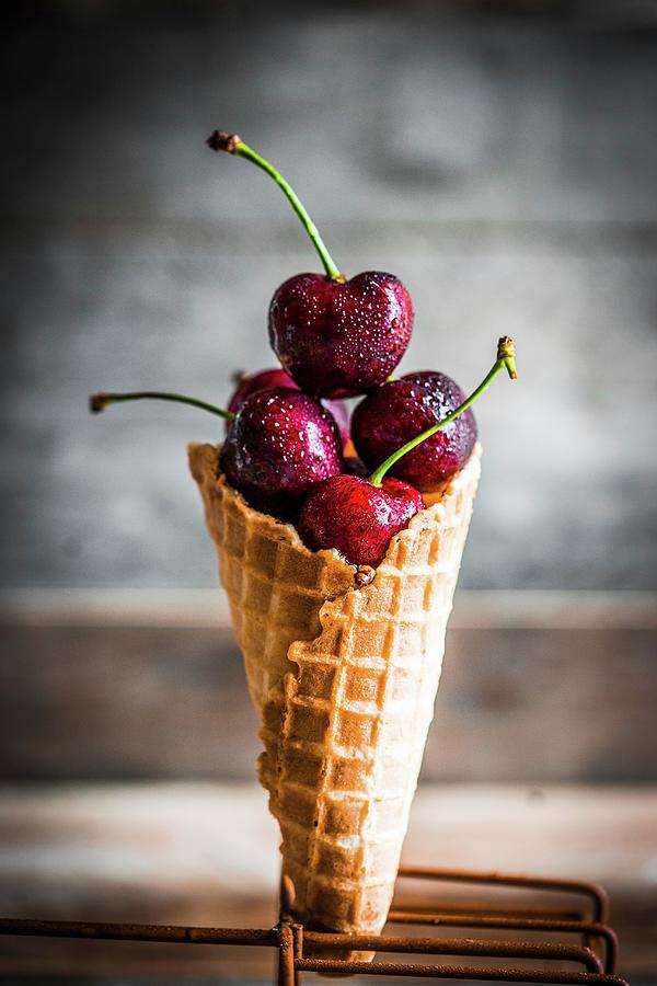 Fresh Cherries In An Ice Cream Cone Photograph by Alena Haurylik