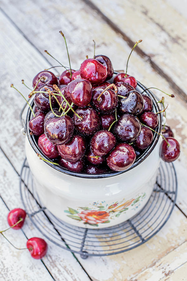 Fresh Cherries In Enamel Bucket With Water Droops Photograph by Anna Jakutajc-wojtalik