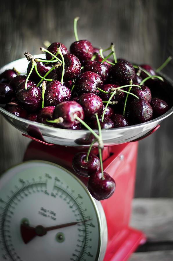 Fresh Cherries On A Kitchen Scale Photograph by Donna Crous