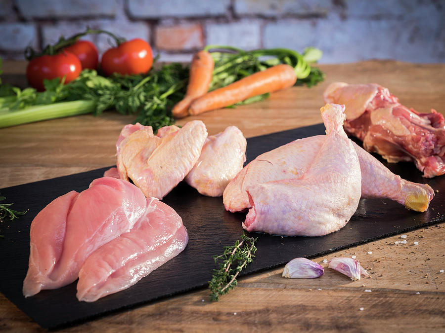 Fresh Chicken, Divided Into Breasts, Drumsticks, Wings And Carcasses, With Soup Vegetables Behind Photograph by Niklas Thiemann