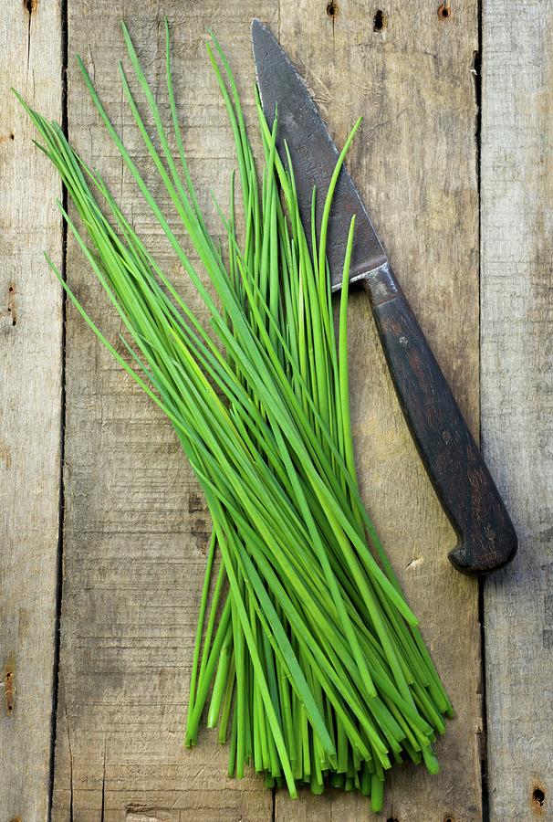 Fresh Chives With A Knife On A Wooden Surface Photograph by Jonathan Short